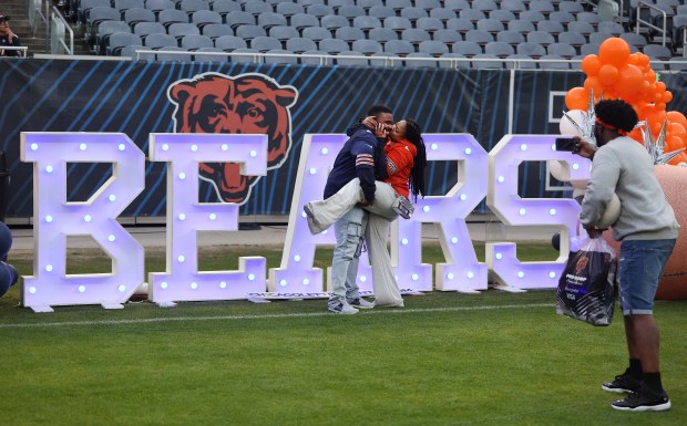 Torian Hughes and Jasmine Jackson share a kiss while attending the Bears draft party at Soldier Field on April 24, 2025. (Chris Sweda/Chicago Tribune)