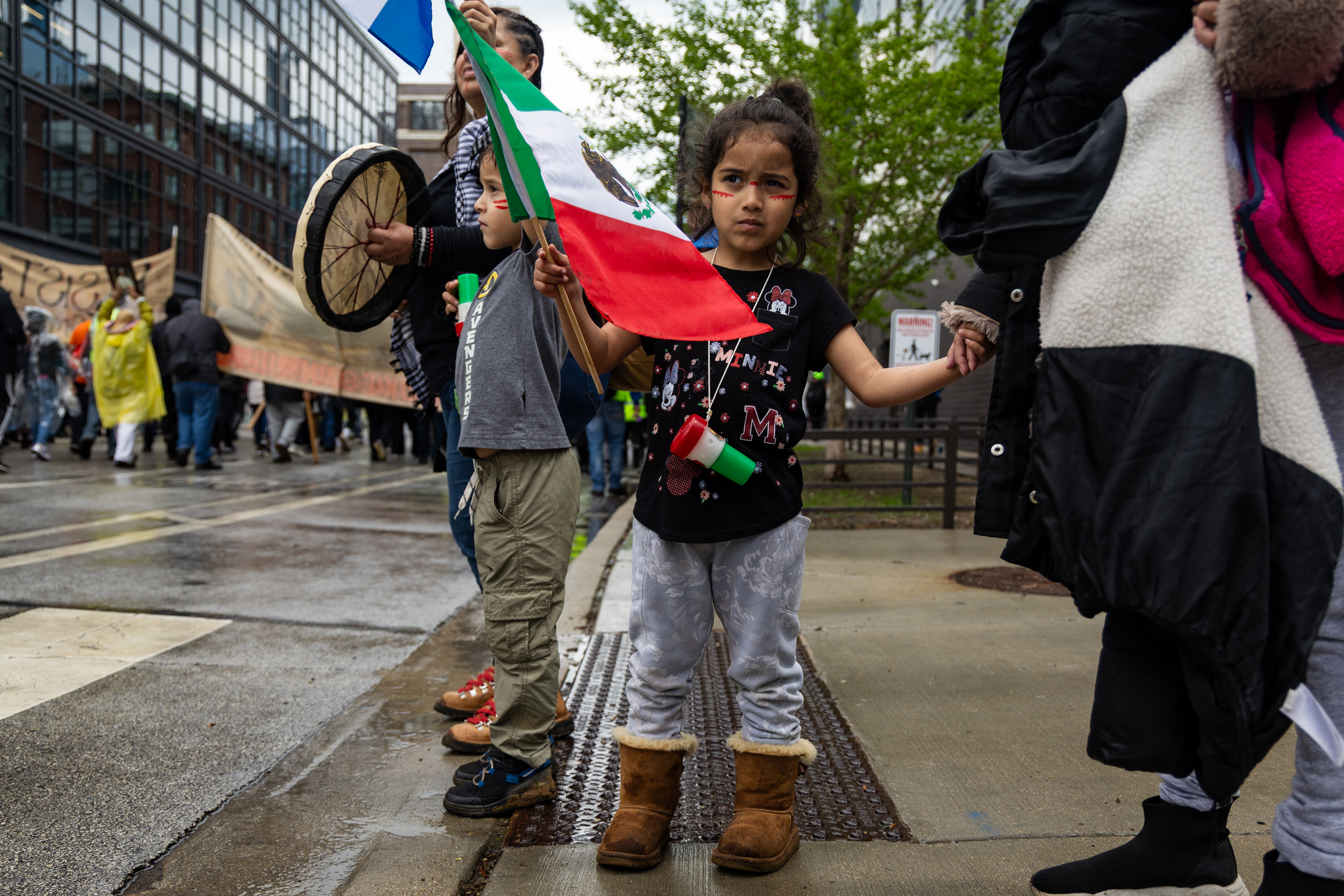 Vianey Mejia, 4, watches as thousands march from Union Park to Grant Park for the May Day march on May 1, 2025. (Audrey Richardson/Chicago Tribune)