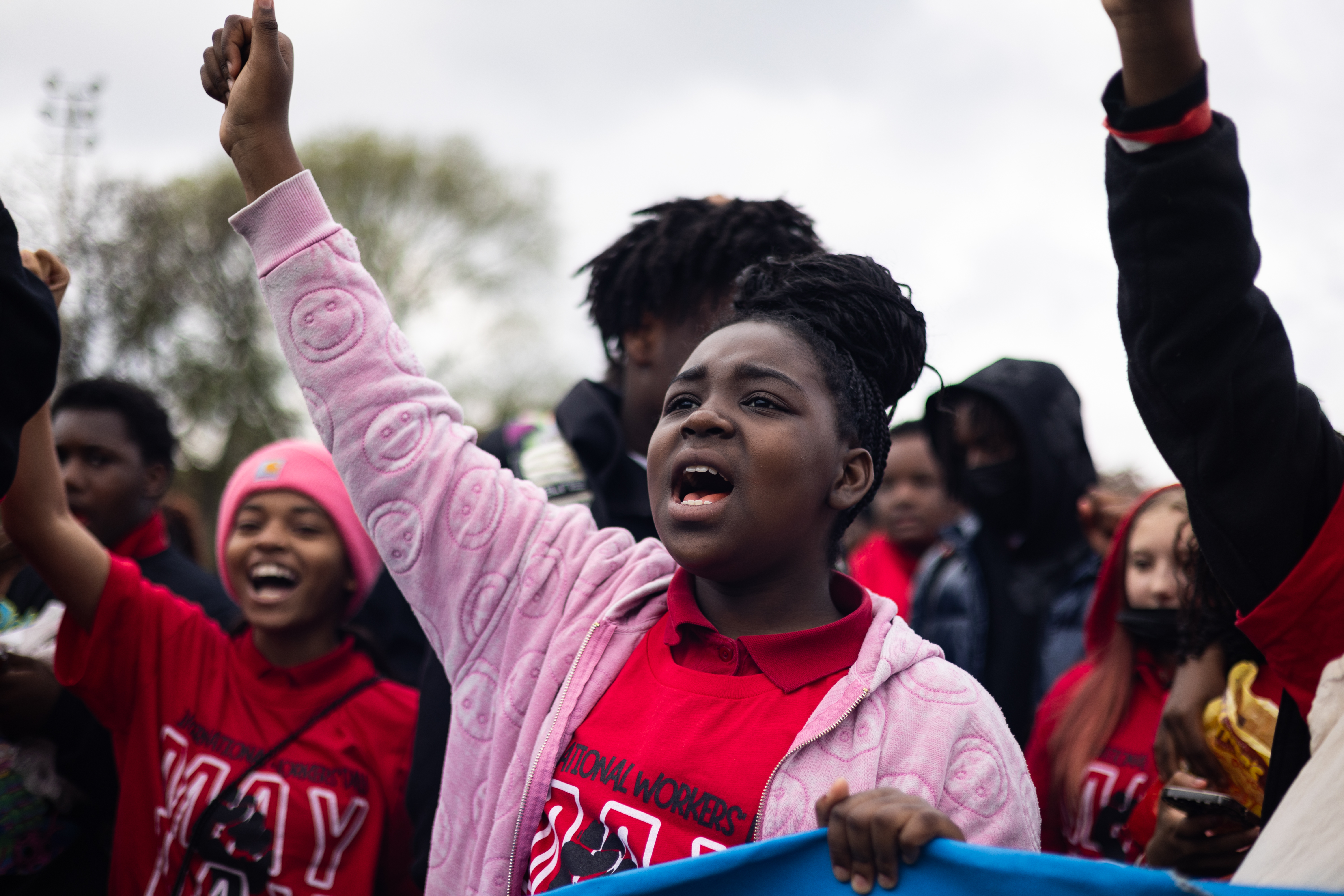 Students with Willa Cather Elementary School, hold their fist up to protest school closures as thousands gather at Union Park before marching to Grant Park for the May Day march on May 1, 2025. (Audrey Richardson/Chicago Tribune)