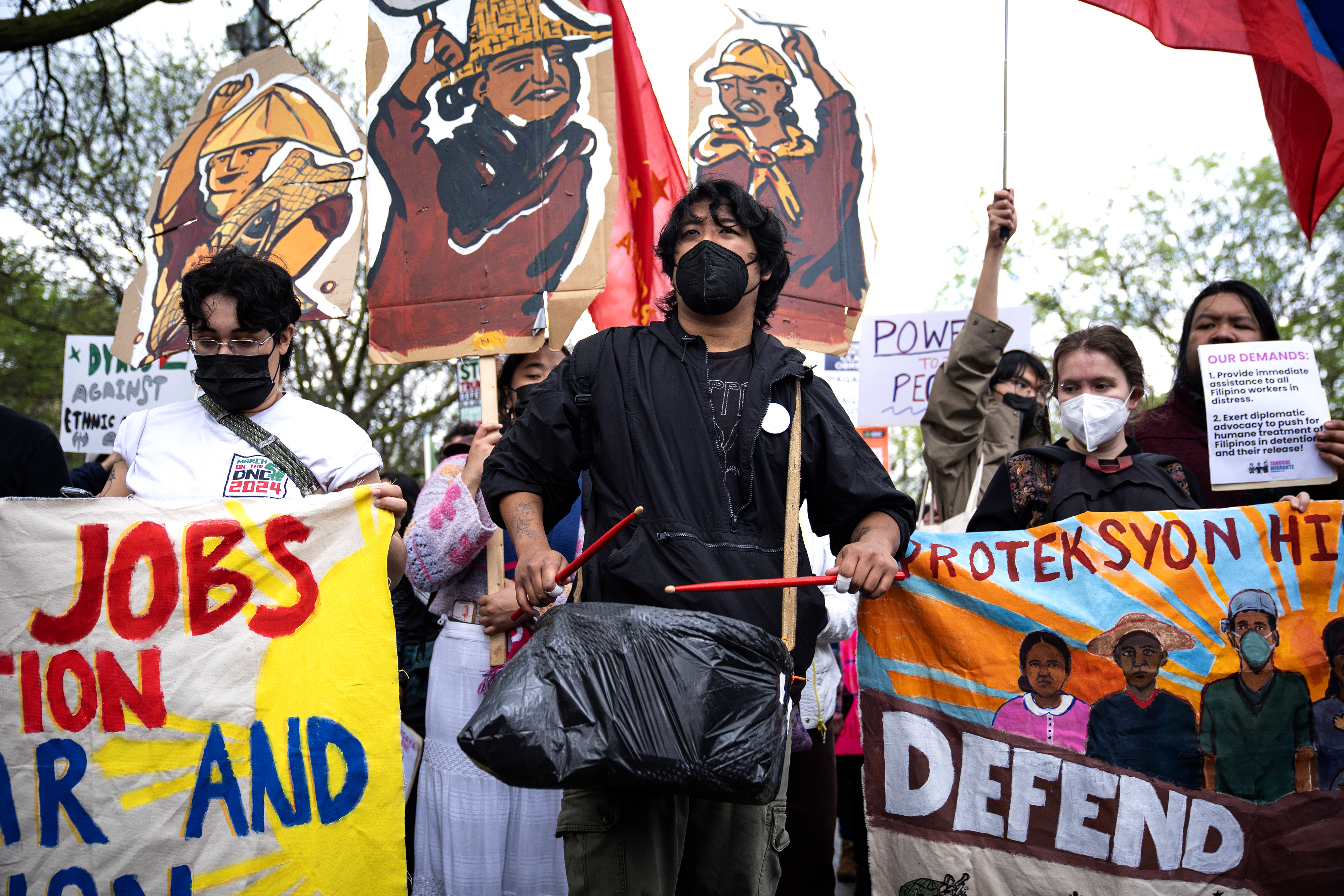 Craig Ymson drums with the group Filipino student and youth group Anak Bayan during the May Day rally in Union Park, May 1, 2025. (E. Jason Wambsgans/Chicago Tribune)