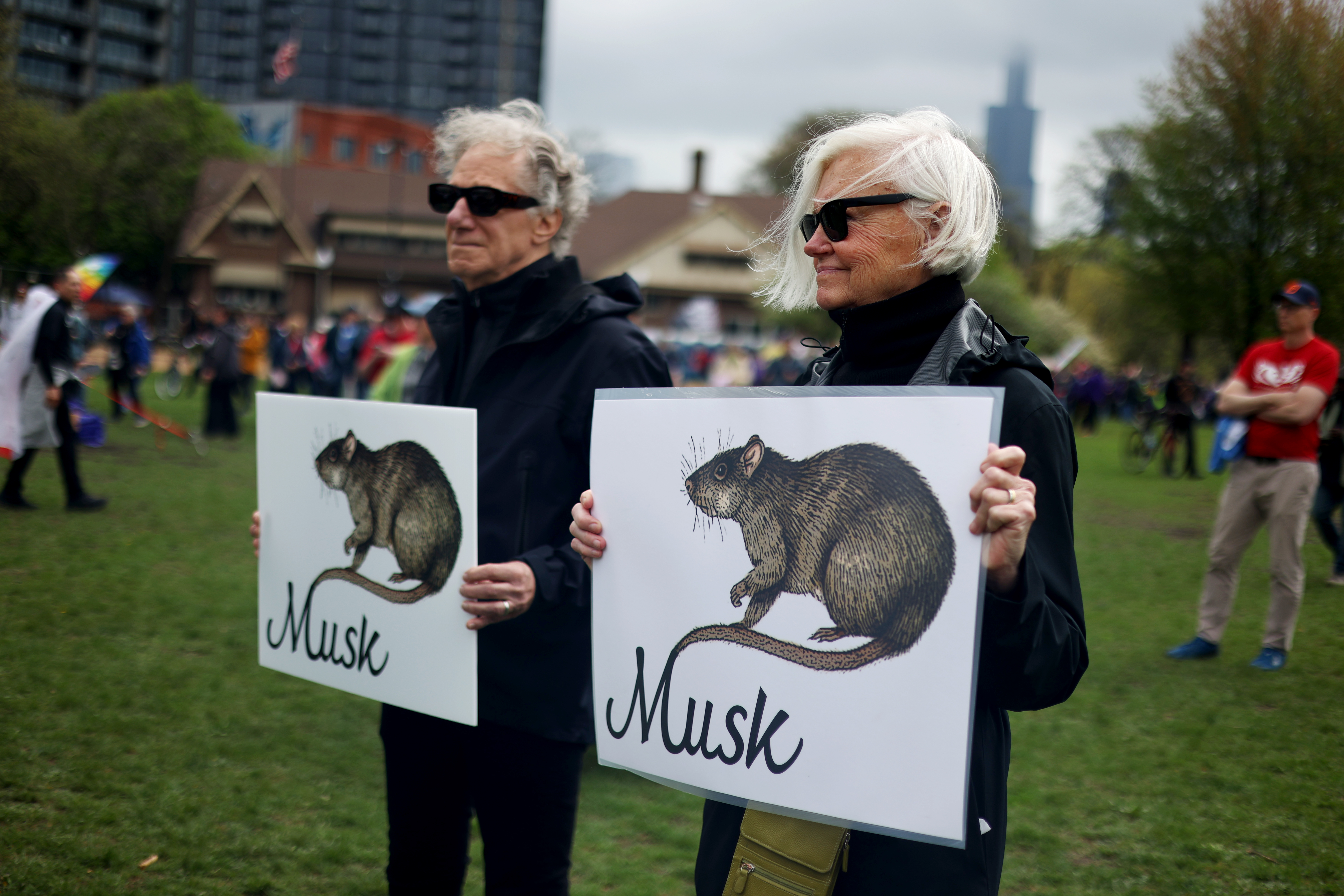 Husband and wife Steve and Deborah hold signs while gathering at Union Park for the May Day march, May 1, 2025, honoring working people for International Workers' Day, before marching to Grant Park. (Audrey Richardson/Chicago Tribune)