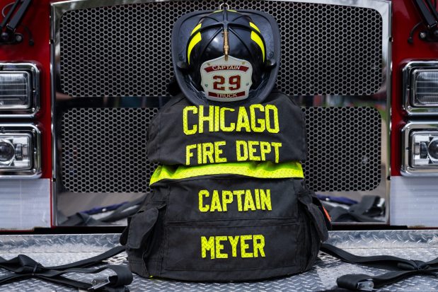 The bunker coat of Chicago Fire Department Capt. David Meyer, who died last week after responding to a West Side garage fire, is displayed on the front of Truck 29 at his funeral, on April 29, 2025, at St. John Brebeuf Church in Niles. (Audrey Richardson/Chicago Tribune)