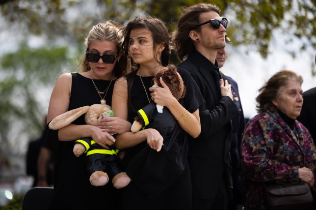Children of Capt. David Meyer from left, Alyssa Meyer, Kaitlyn Meyer and Michael Meyer, attend his funeral service on April 29, 2025, at St. John Brebeuf Church in Niles. (Audrey Richardson/Chicago Tribune)