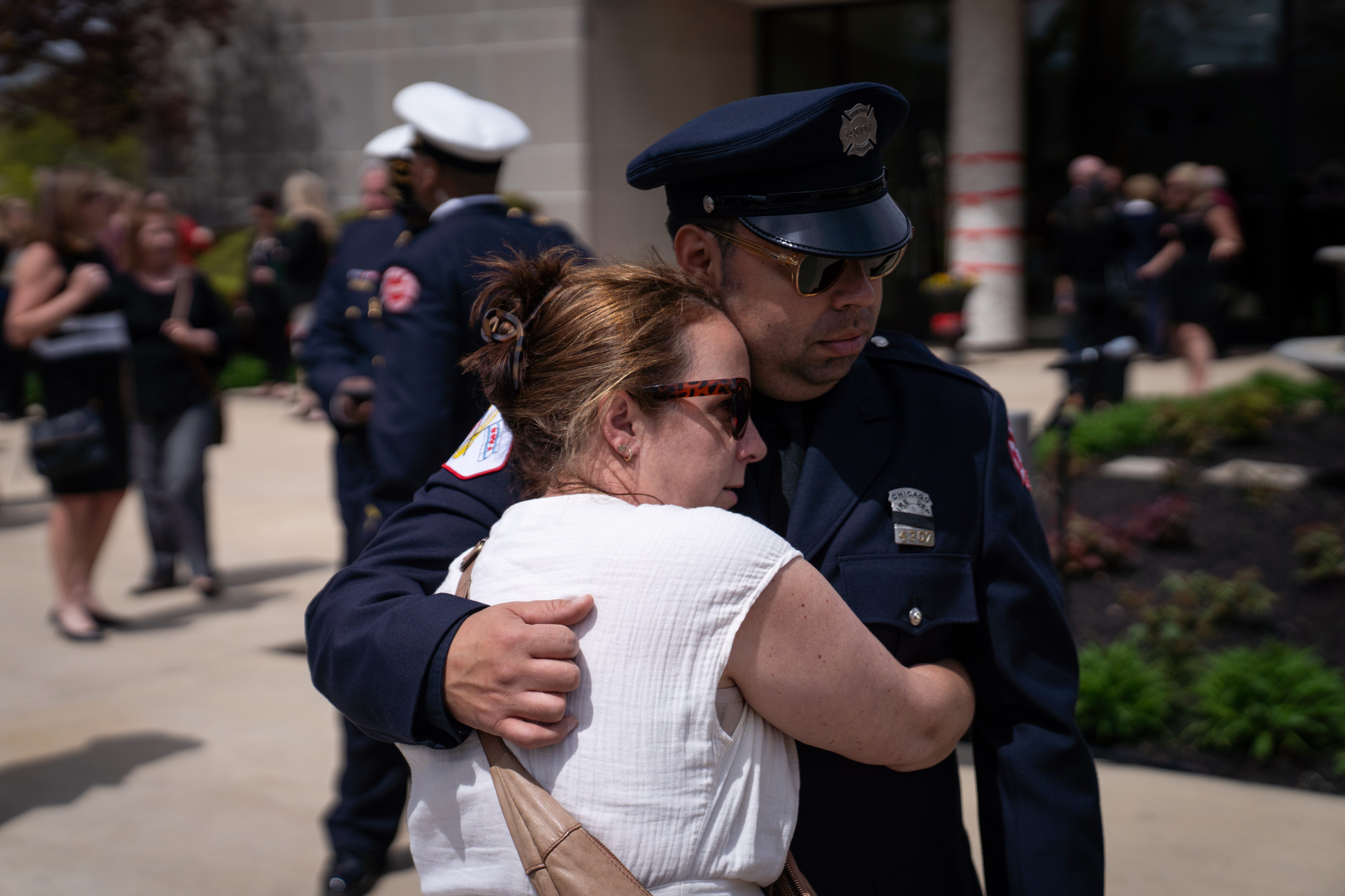 Julie Williams embraces her husband, Firefighter Kenny Williams, after the funeral service for Capt. David Meyer, who died last week after responding to a West Side garage fire, on April 29, 2025, at St. John Brebeuf Church in Niles. Kenny Williams was on duty responding to the fire with David Meyer and was next to him during the accident, Julie Williams said. (Audrey Richardson/Chicago Tribune)