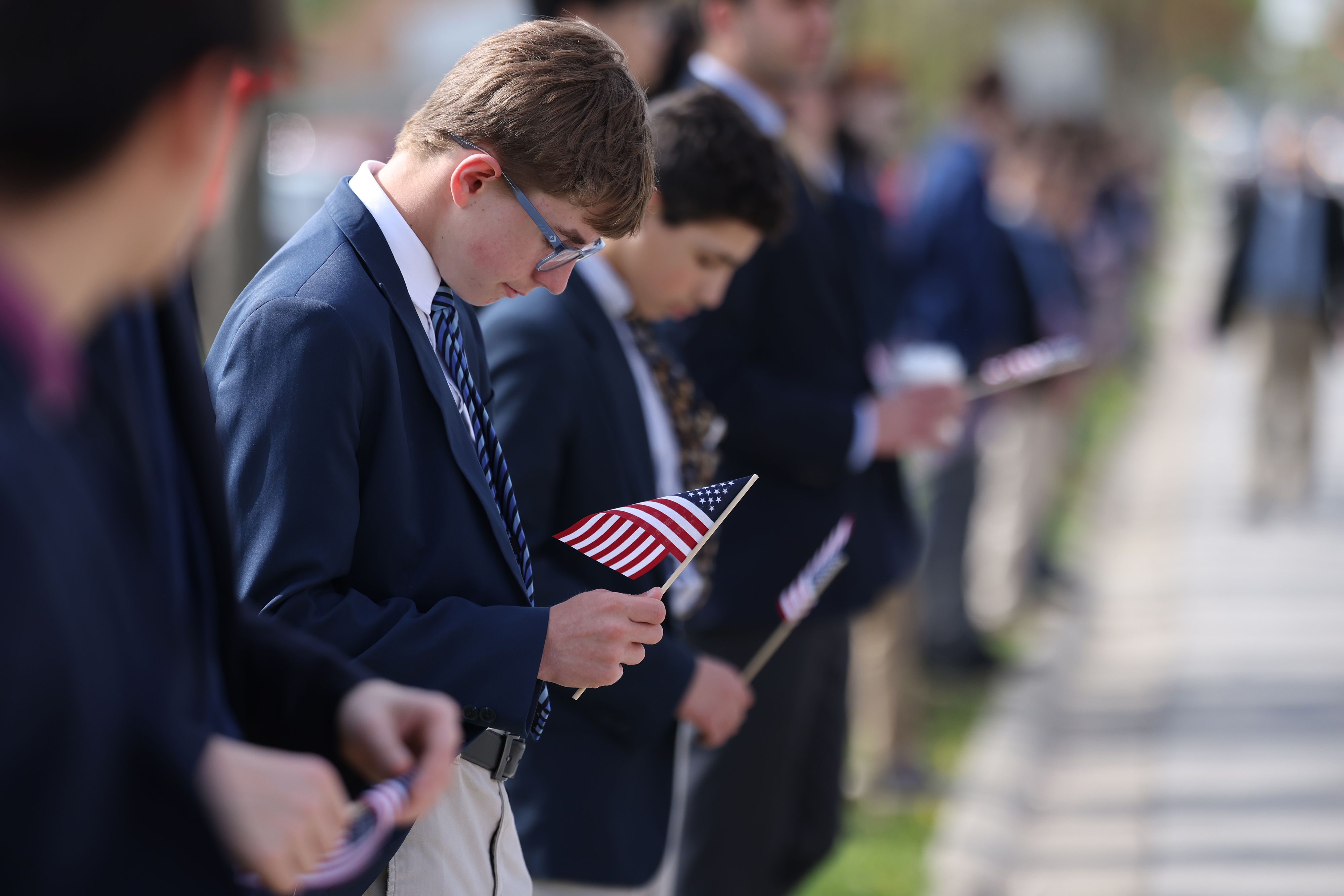 Students from North Ridge High School line the streets for a funeral procession for Chicago Fire Department Capt. David Meyer on April 29, 2025. Meyer was killed in the line of duty last week battling a West Side garage fire. (Antonio Perez/Chicago Tribune)