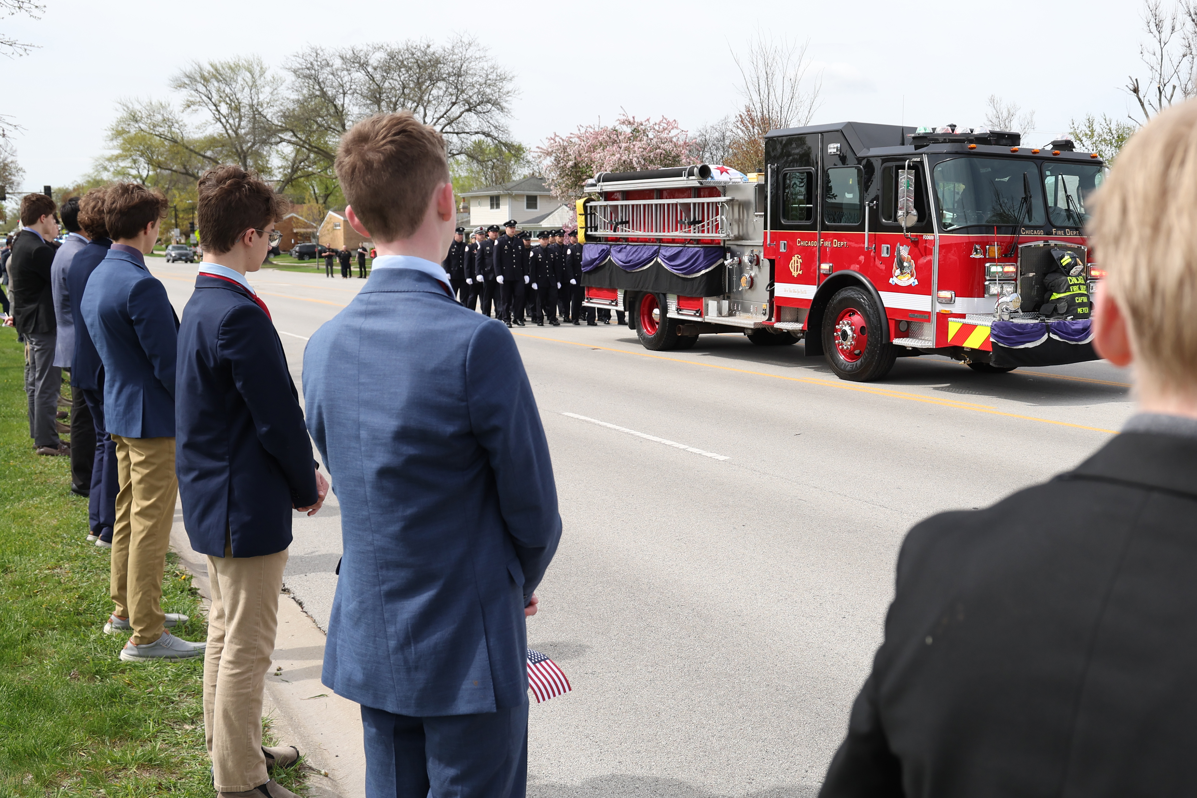 Students from North Ridge High School line the streets for a funeral procession for Chicago Fire Department Capt. David Meyer on April 29, 2025. Meyer was killed in the line of duty last week battling a West Side garage fire. (Antonio Perez/Chicago Tribune)