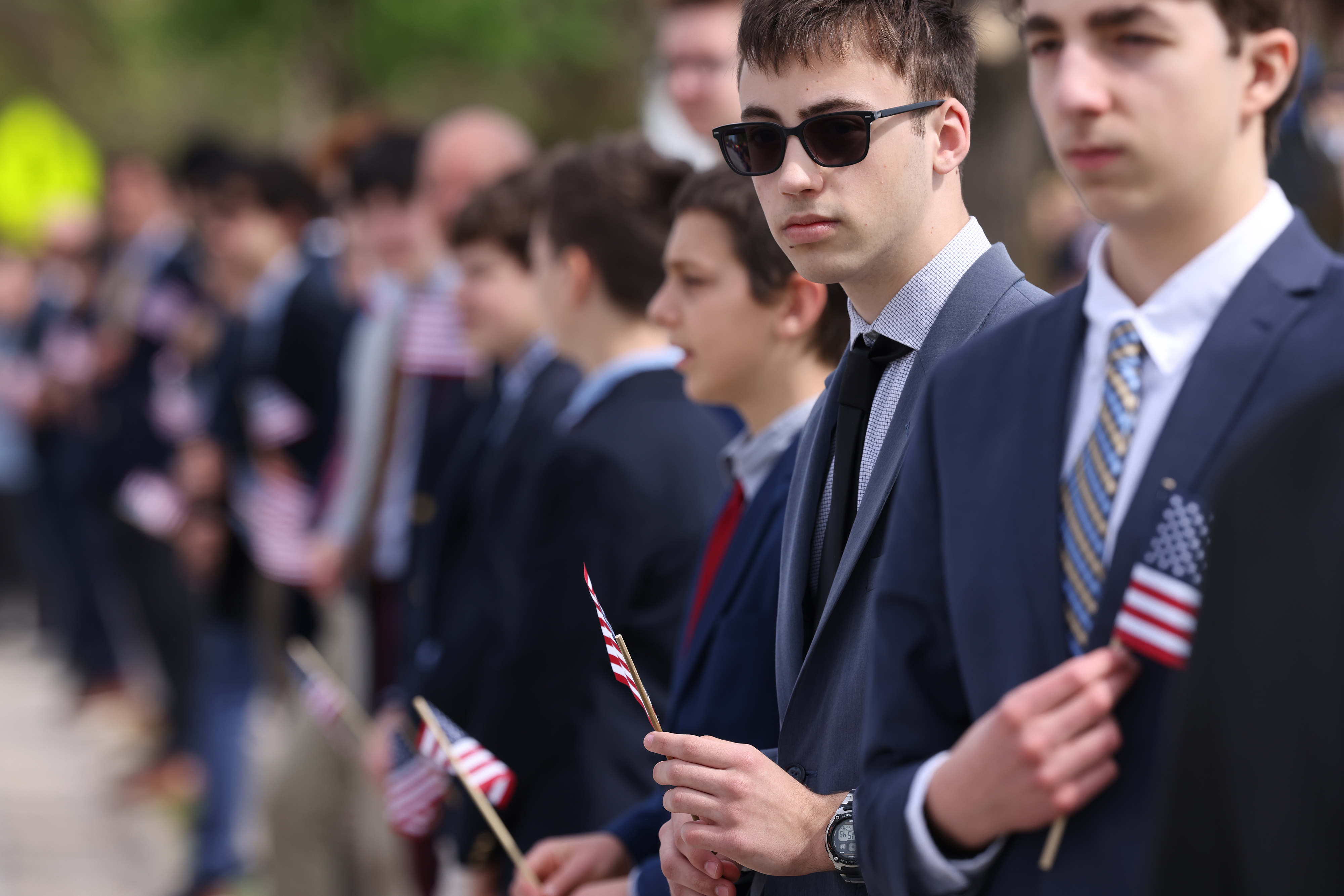Students from North Ridge High School line the streets for a funeral procession for Chicago Fire Department Capt. David Meyer on April 29, 2025. Meyer was killed in the line of duty last week battling a West Side garage fire. (Antonio Perez/Chicago Tribune)