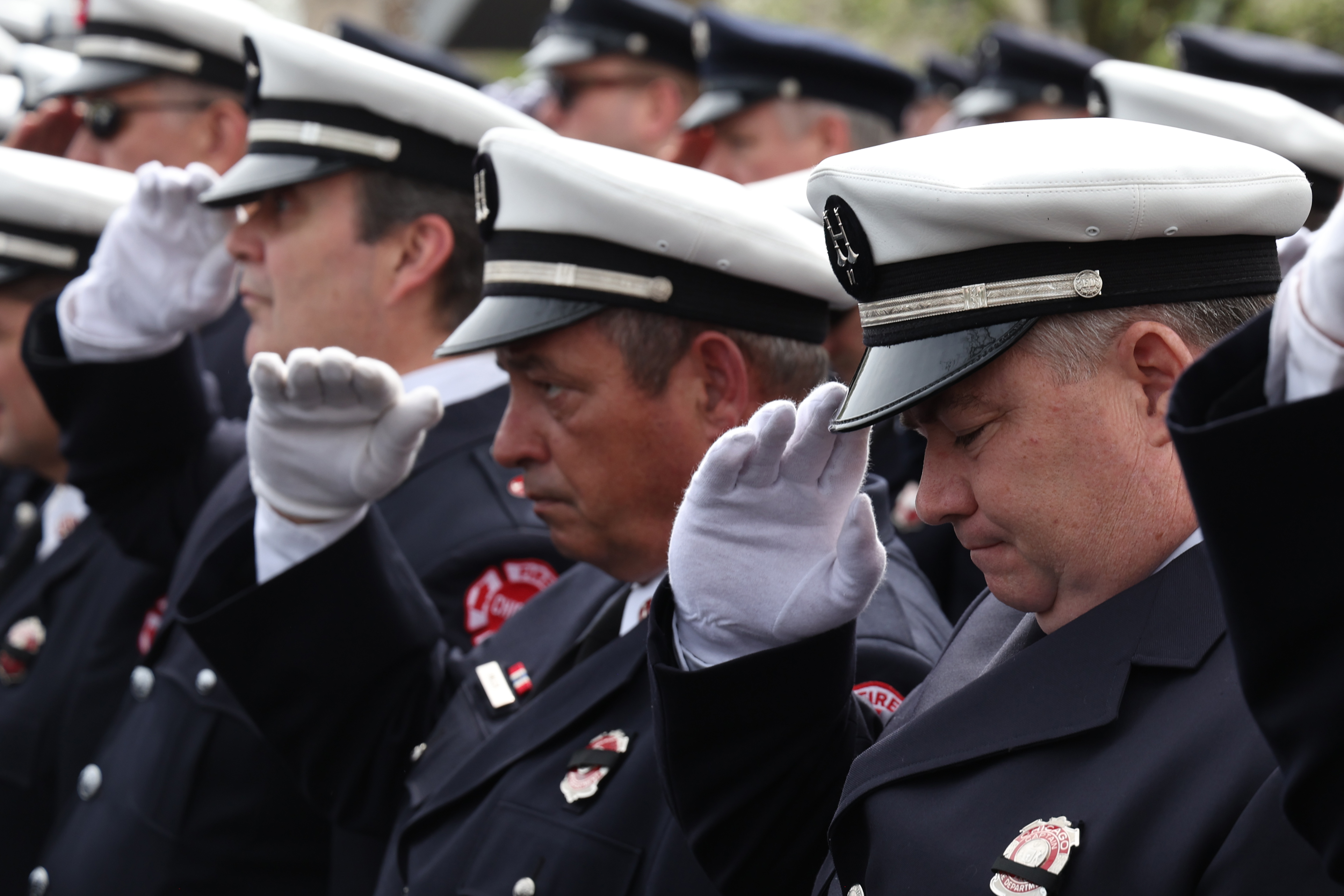 Chicago firefighters salute in honor of fallen Chicago Fire Department Capt. David Meyer at St. John Brebeuf Church in Niles, Tuesday, April 29, 2025. (Antonio Perez/Chicago Tribune)