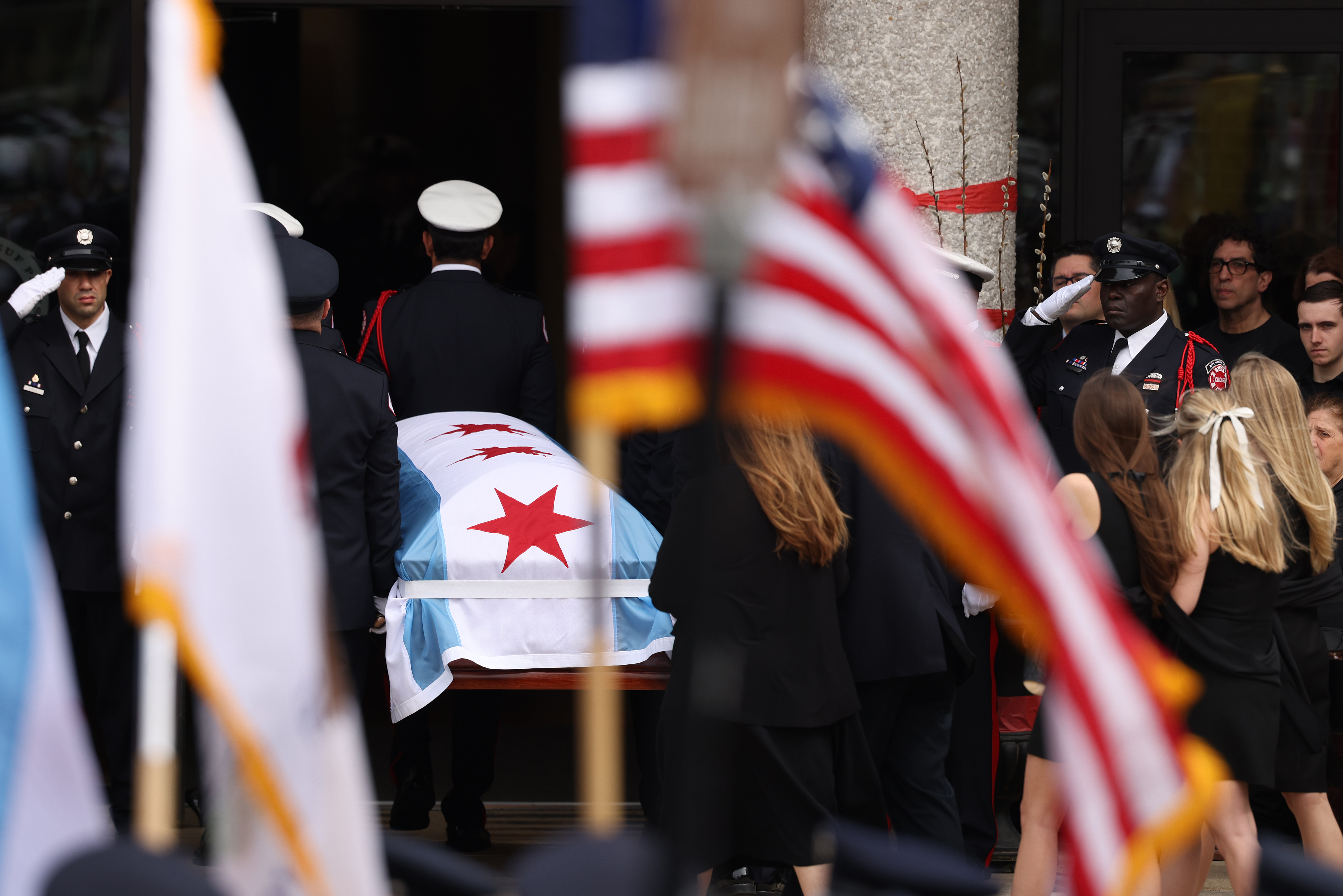 Family members and loved ones look on as the casket of fallen Chicago Fire Department Capt. David Meyer is moved into St. John Brebeuf Church in Niles, April 29, 2025. Meyer was killed in the line of duty last week battling a West Side garage fire. (Antonio Perez/Chicago Tribune)