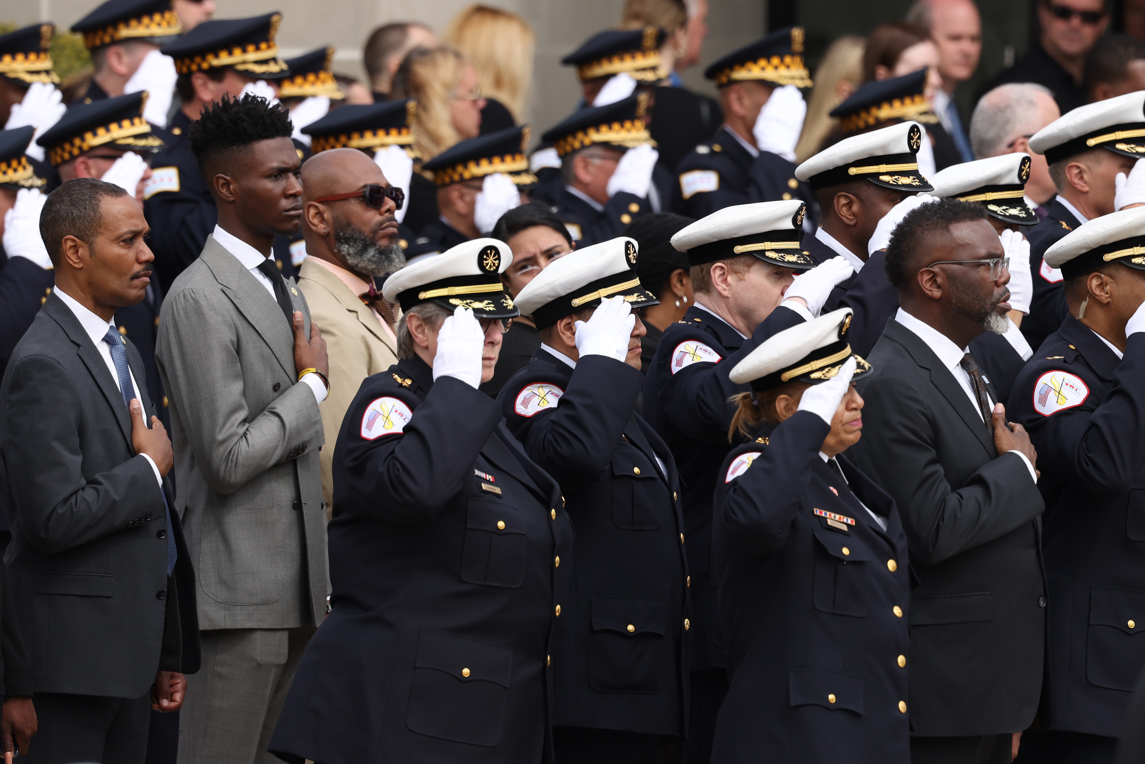 Mayor Brandon Johnson and firefighters salute as the casket of fallen Chicago Fire Department Capt. David Meyer is moved into St. John Brebeuf Church in Niles, April 29, 2025. (Antonio Perez/Chicago Tribune)