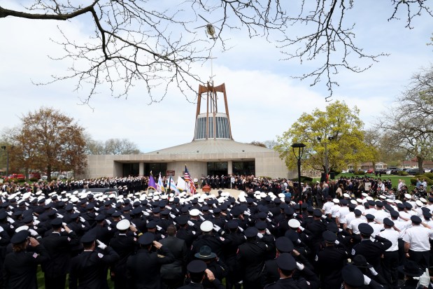 A Chicago fire department helicopter performs a flyover following funeral services for fallen Chicago Fire Department Capt. David Meyer at St. John Brebeuf Church in Niles, April 29, 2025. Meyer was killed in the line of duty last week battling a West Side garage fire. (Antonio Perez/Chicago Tribune)